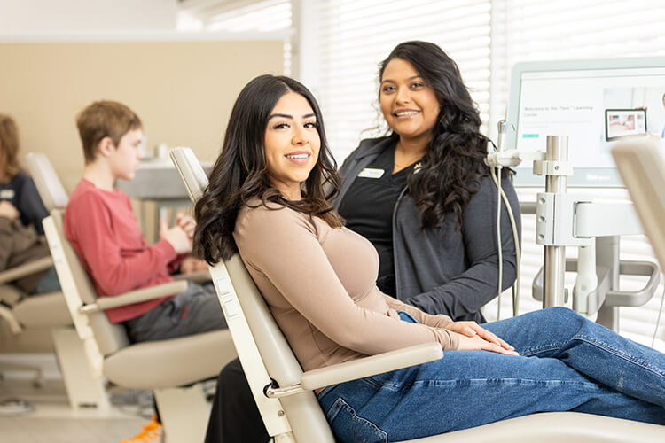 Google Reviews, two smiling women in a dental office chair area