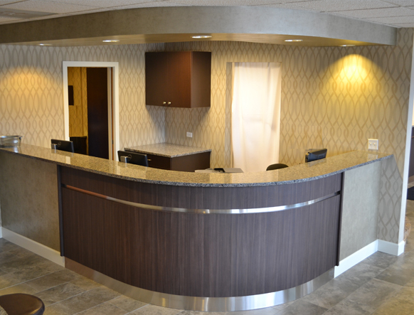 Gurnee reception desk with curved wood counter and granite top