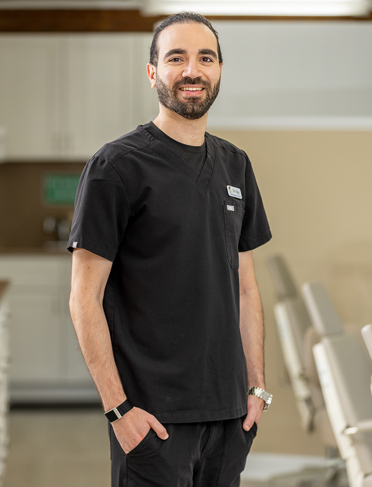 Dr. Ahmed Nagy, smiling in a suit and tie